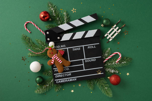A creative composition featuring a film clapperboard, Christmas decorations, including candy canes, gingerbread, and baubles. Perfect for holiday-themed cinematic projects and seasonal celebrations