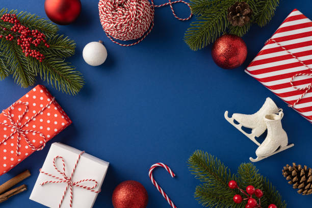 istock A festive composition featuring Christmas decorations with presents, ornaments, and greenery on a blue backdrop capturing holiday spirit 2180007654