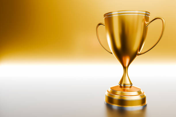 istock gold trophy award Winner trophy isolated on golden background with copy space for text. Rendering. 3D illustration. 2180010353