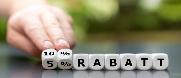 istock Hand turns dice and changes the German expression '5% Rabatt' (5% discount) to '10% Rabatt' (10% discount) 2180012636