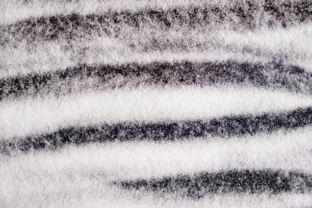 istock Finely ground stone white rock salt texture on black background, top view. 2180012781