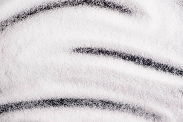 istock Finely ground stone white rock salt texture on black background, top view. 2180012848