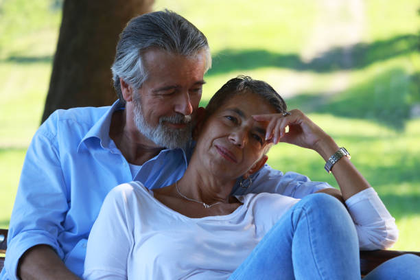 istock Senior couple exchange affection in autumn day 2180015719