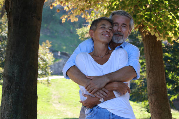 istock Senior couple exchange affection in autumn day 2180015749