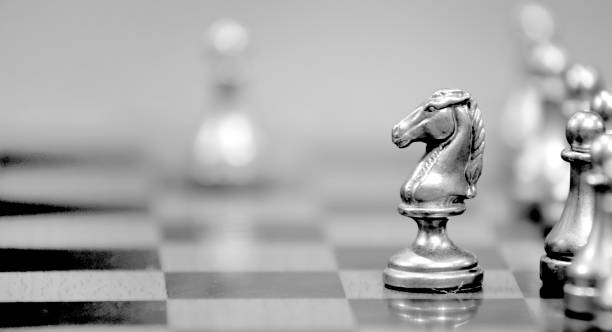 Chess Pieces on Board for Game and Strategy Knight Attacking