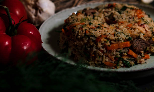 istock Spanish rice, uzbek pilaf hot dish with meat and vegetables, rustic table kitchen decoration with ingredients 2180021298