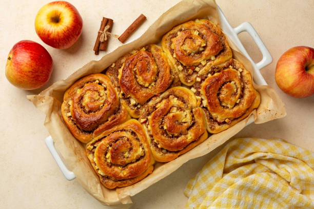 istock Top view Homemade baked Rolls Buns with apples, walnut and cinnamon. Beige table background. 2180021627