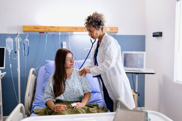istock Doctor listening to patient's back during examination 2180022002