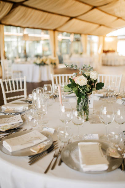 istock Table setting for an event party or wedding reception. Fresh flower table decoration 2180024262