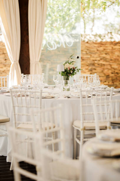 istock Table setting for an event party or wedding reception. Fresh flower table decoration 2180024288