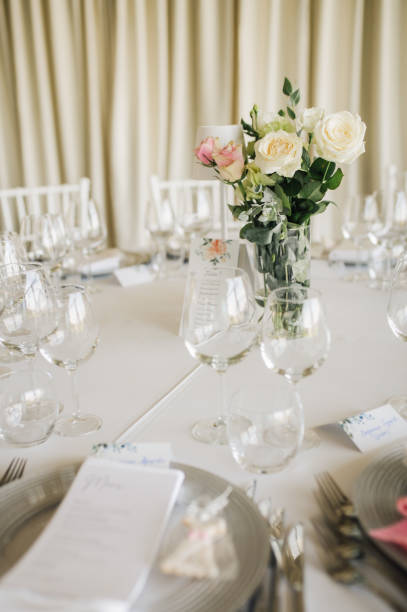 istock Table setting for an event party or wedding reception. Fresh flower table decoration 2180024290
