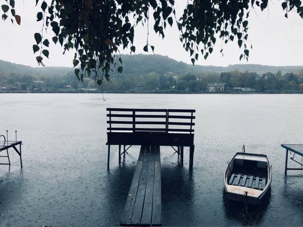 Lonely boat on the lake in the rain