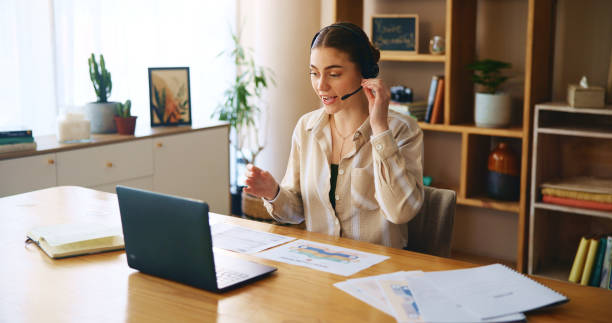 istock Remote work from home, computer and woman with headphones, virtual meeting and documents. Person, freelancer and entrepreneur with pc, headset and online seminar with presentation and communication 2180024980