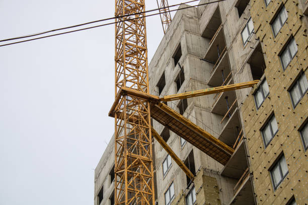 A Modern Construction Site Featuring Cranes Operating Against a Beautiful, Clear Blue Sky