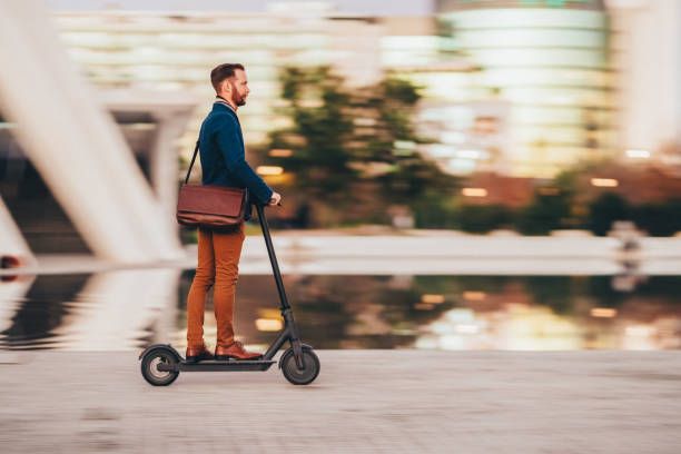 istock Businessman riding scooter at evening 2180029207