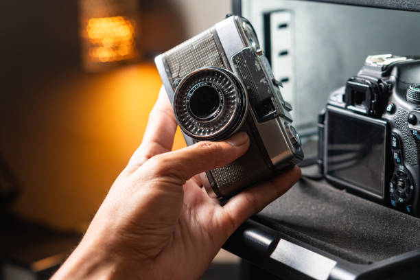 istock Hand Pulling Camera Storage Drawer with Vintage and SLR Cameras 2180029847