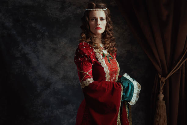 istock medieval queen in red dress on dark gray background 2180030542