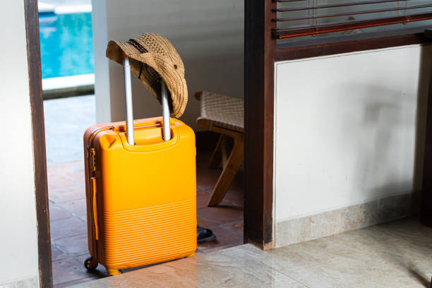 istock Woman with Orange Suitcase by Poolside 2180031354