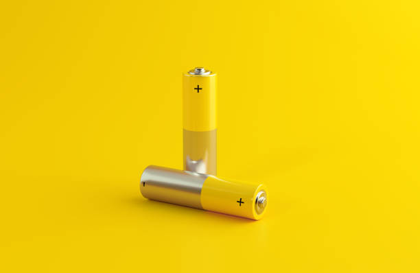 istock Yellow AA Battery Pair On Yellow Background 2180031506