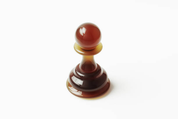 Amber colored glass pawn on white background. Horizontal composition with clipping path and copy space.