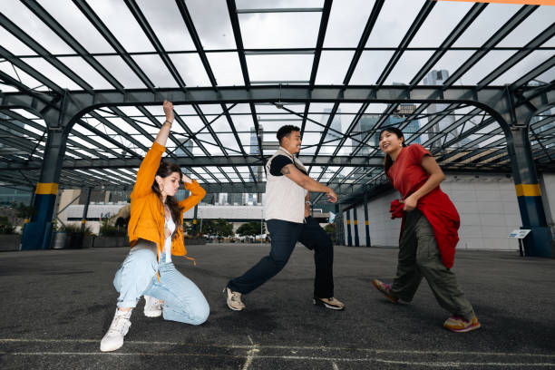 istock Group of young people dancing outdoors 2180037010