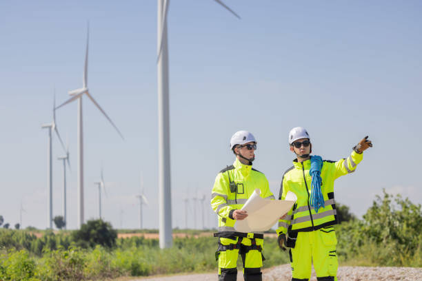 istock Engineers are having a discussion at wind turbine field 2180039460