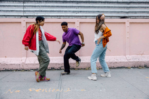 istock Group of young people dancing outdoors 2180041845