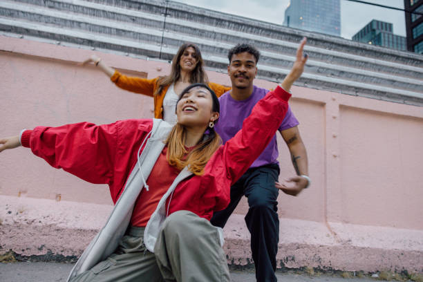 istock Group of young people dancing outdoors 2180042031