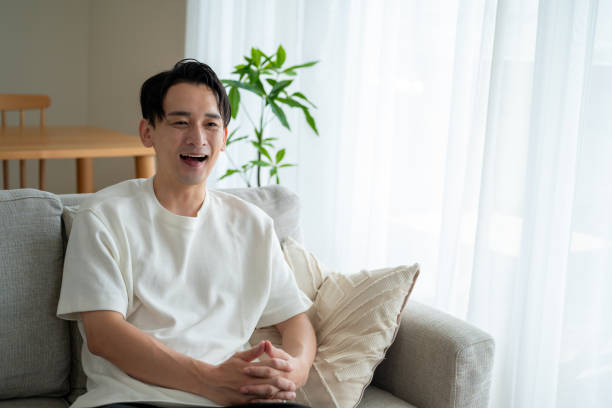 istock A Japanese man relaxing on the sofa 2180044423