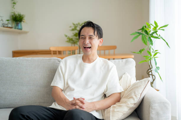 istock A Japanese man relaxing on the sofa 2180044444