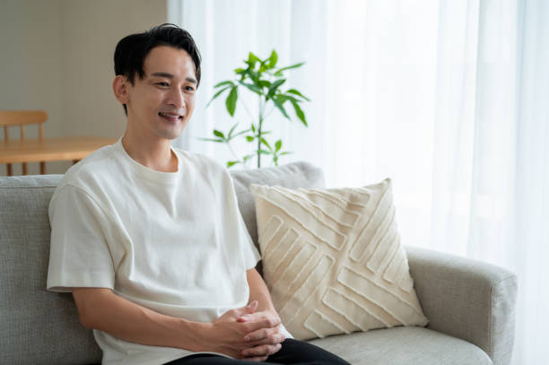 istock A Japanese man relaxing on the sofa 2180044493
