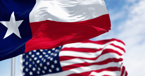 istock Texas state flags waving in the wind with american flag 2180048572