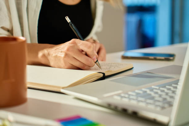 istock Illustrator drawing sketches in notebook at home office desk 2180050956
