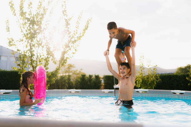 istock Teenagers having fun jumping in the swimming pool 2180051630