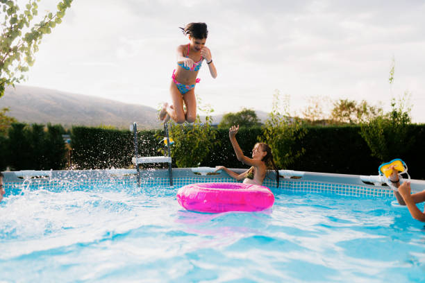istock Teenagers having fun jumping in the swimming pool 2180051655