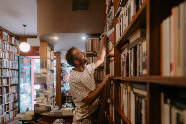 istock Male librarian working in a bookstore 2180052951