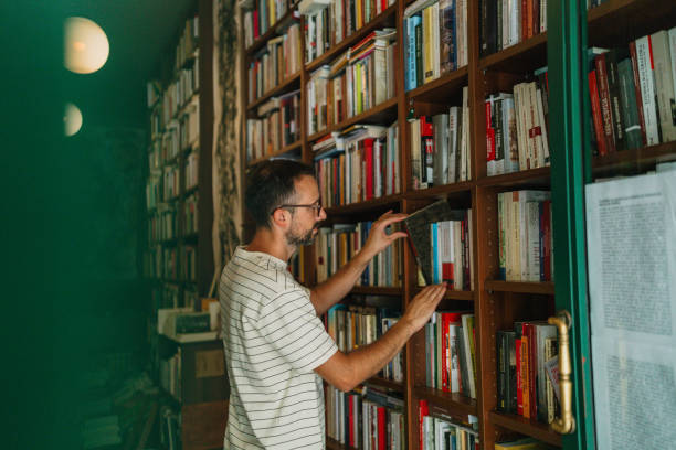 istock Male librarian working in a bookstore 2180052990