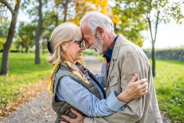 istock Embraced senior couple spending a day in the park 2180054575