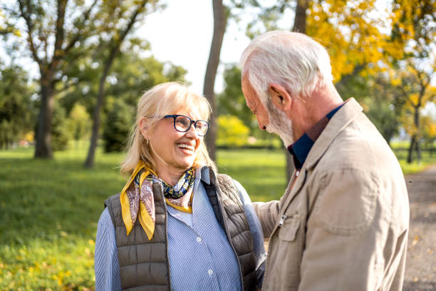 istock Happy senior couple in autumn park 2180055382