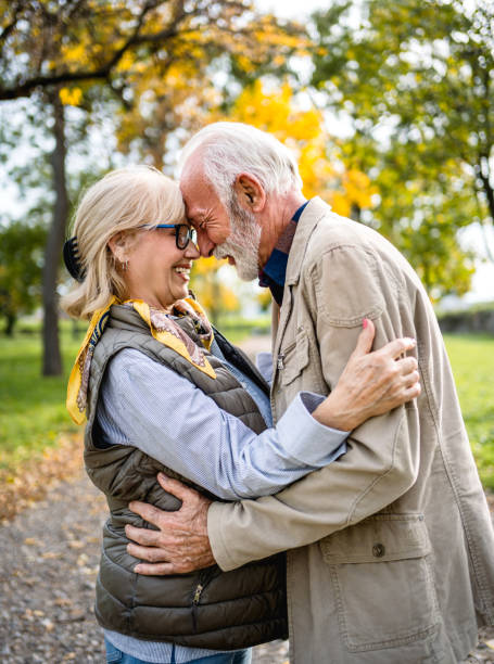 istock Embraced senior couple spending a day in the park 2180055775