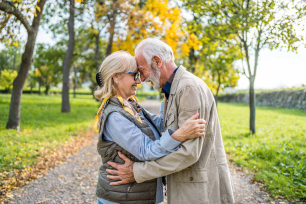 istock Embraced senior couple spending a day in the park 2180055881