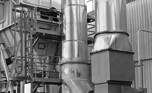 Close-up of outdoor duct work at a factory. Black-and-white photo.