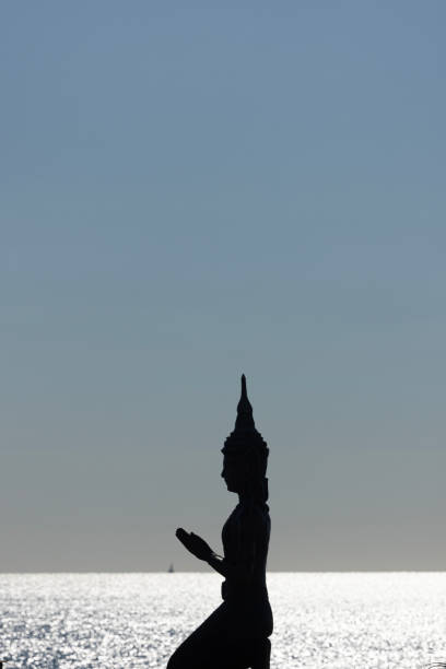 buddha statue in front of the beach