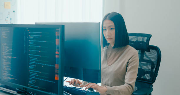 istock Young adult Asia female freelance typing write prompt AI bot IT app smart program nomad, video game, terminal with coding language, user interface, designer, big data center on computer. 2180062040