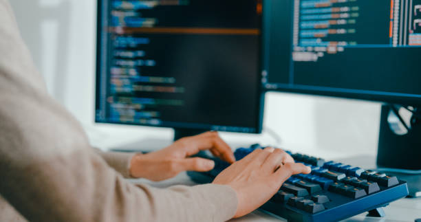 istock Closeup young adult Asia female freelance type write prompt AI bot IT app smart program nomad, video game, terminal with coding language, user interface, designer, big data center on computer. 2180062126