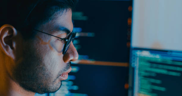 istock Closeup young adult Asia male freelance typing write prompt AI bot IT app smart program nomad, video game, terminal with coding language, designer, big data center on computer in night office. 2180062151