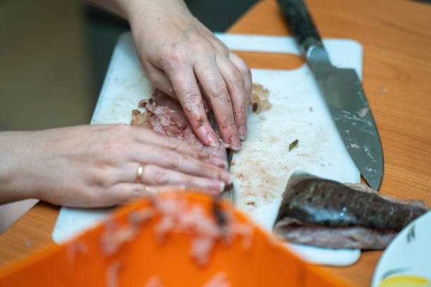 istock Delicate hands expertly extract bones from a fresh fish, transforming it into a beautiful fillet. This artful process showcases the fusion of skill, tradition, and culinary creativity 2180062264