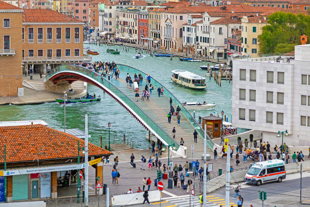Venice, Italy - October 10, 2024: Santiago Calatrava bridge with glass design over the canal in Venice with tourists walking across during sunny day in Italy