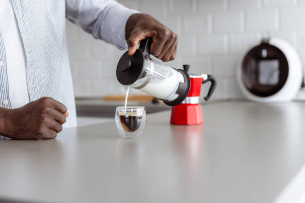 istock Man preparing coffee with milk at home in modern kitchen 2180063604