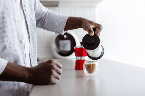 istock Man preparing coffee with milk at home in modern kitchen 2180063617